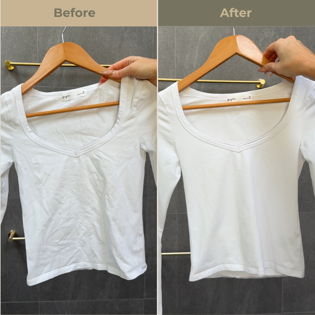 Comparison of a white top before and after using Uncrumpled anti-crease spray. Side labeled 'Before' appears wrinkled while the side labeled 'after' appears smoother with no wrinkles. The white top is held up by a hand against a gray tiled bathroom wall.