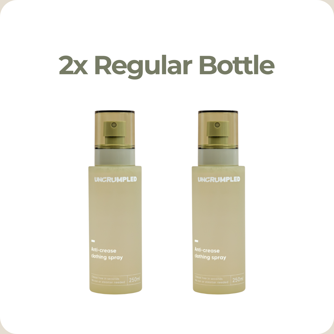 Two bottles of regular-sized Uncrumpled anti-crease clothing spray on a white background