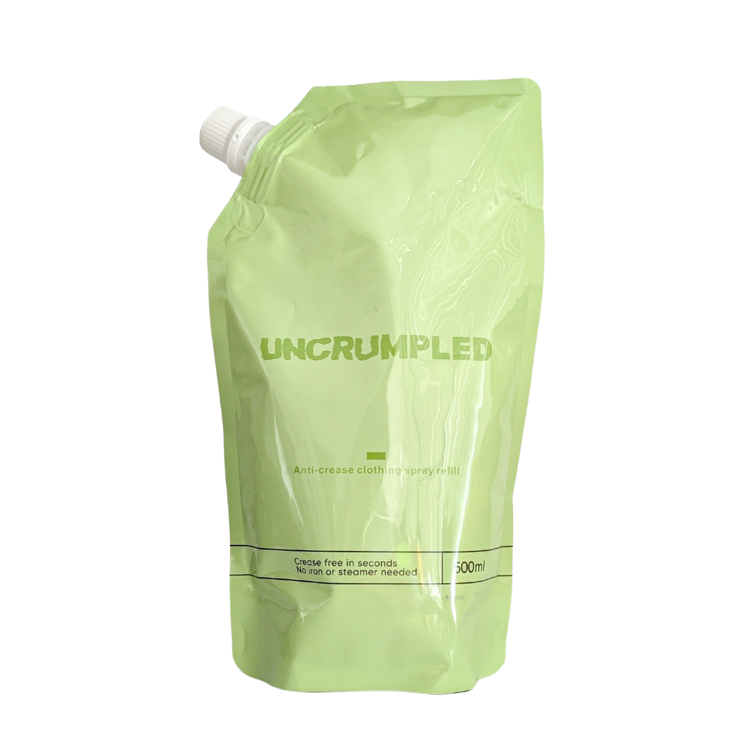 The Uncrumpled refill pouch, a 500ml light green resealable stand-up pouch with a white screw cap, isolated on a white background.